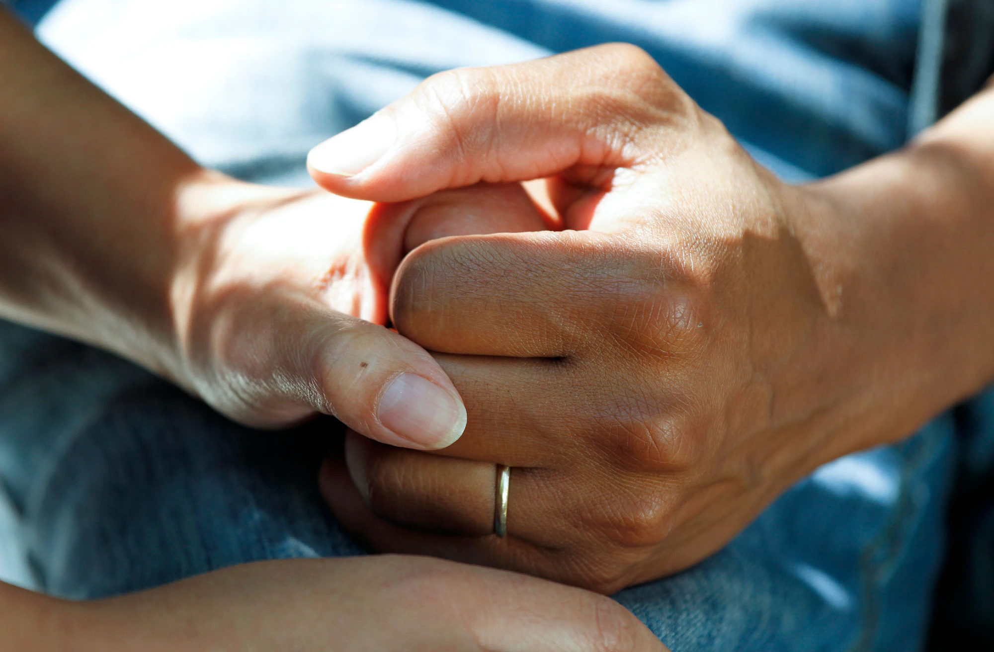 Two people holding hands in support